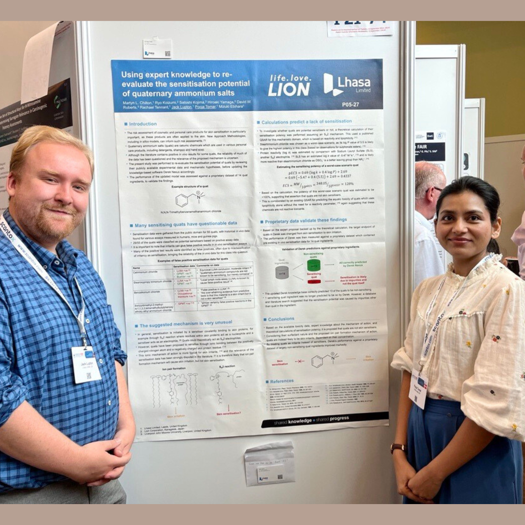 Female and male in front of skin sensitisation poster at Eurotox